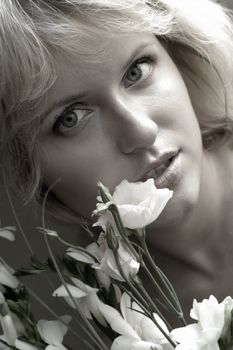 Portrait of the beautiful blonde with a bouquet of flowers