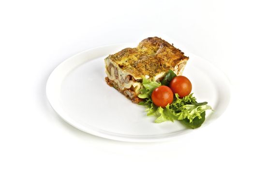 Delicious lasagna with a salad on a plate, lunch or dinner