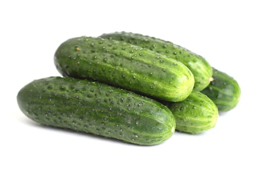 Five green cucumbers it is isolated on white