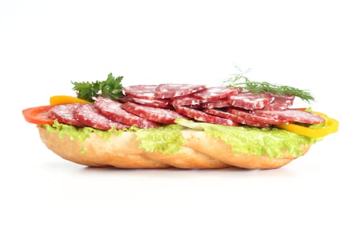 Sandwich with sausage, pepper, a tomato