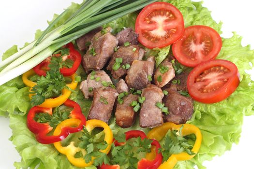 Appetizing shish kebab with tomatoes and greens