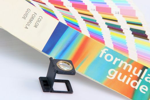 detail pantone colors formula guide with graphic art loupe lense isolated on white background