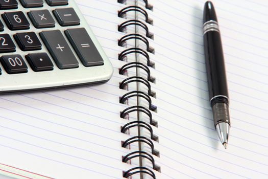 business and office items note book with calculator detail  and black pen