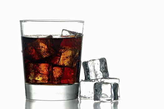 Fresh Cold Cola with ice in glass and next to glass isolated on white background