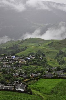 A small chinese village in the Yunnan provence surrounded by rice paddys and mountains