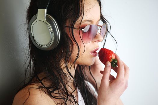 happy woman dance in phones and eat strawberry