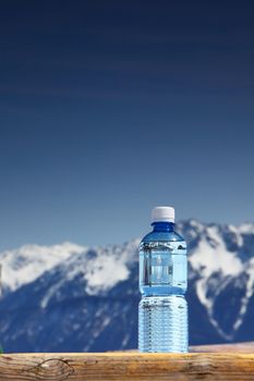 water in cup mountains on background