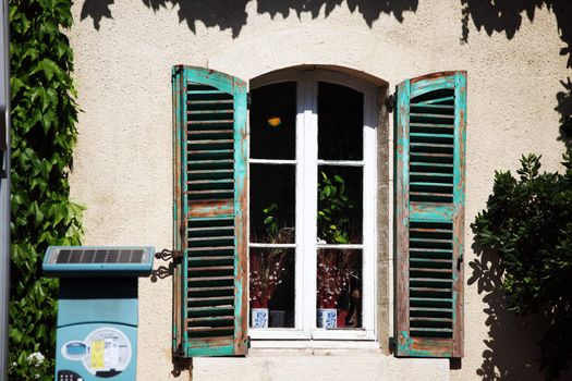 window in green foliage