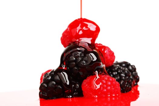 berry mixed pile in syrup isolated on white