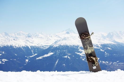  top of mountains in blue sky snowboard on it