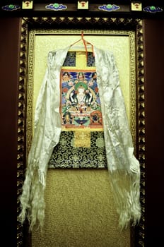 a tibetan silk scarf and wall hanging in a hotel