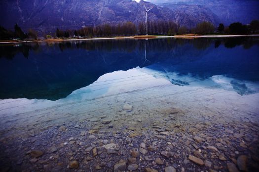 tree reflection in spring mountain lake