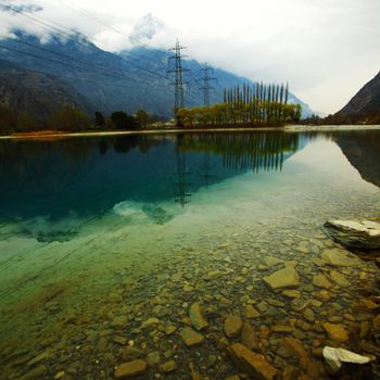 tree reflection in spring mountain lake