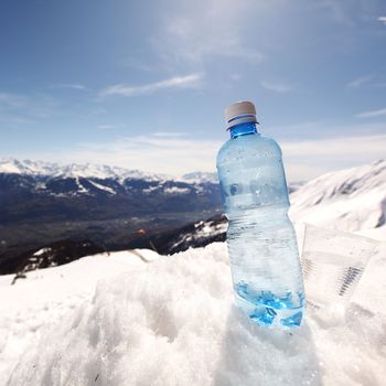 water in cup mountains on background