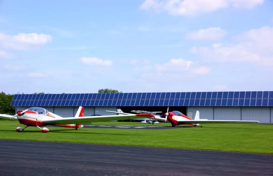 Small airfield with red airplanes