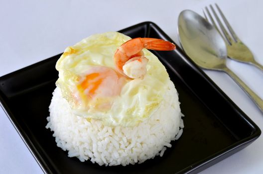a delicious  fried egg and prawn  on steamed rice