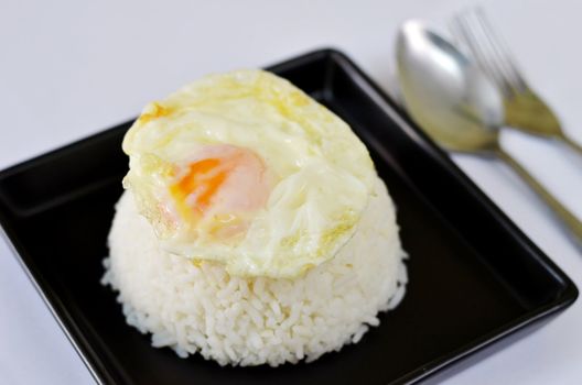 a delicious  fried egg  on steamed rice
