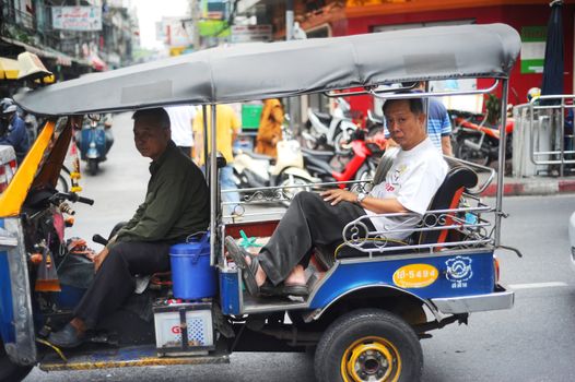 Bangkok, Thailand  -  March 26, 2011: Bangkok Tuk-tuk with passengers in traffic jam