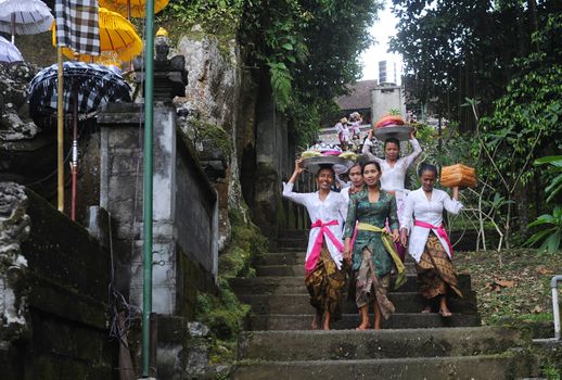 Ubud, Bali island, Indonesia - April, 06, 2011: Unidentified local woman wearing in traditional indonesian clothes take part in Buda Wage Kelawu ceremony at Hindu temple.