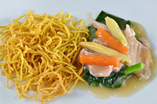 crispy yellow noodle with in a creamy gravy sauce 
