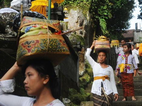 Ubud, Bali island, Indonesia - April, 06, 2011: Unidentified local woman wearing in traditional indonesian clothes take part in Buda Wage Kelawu ceremony at Hindu temple.