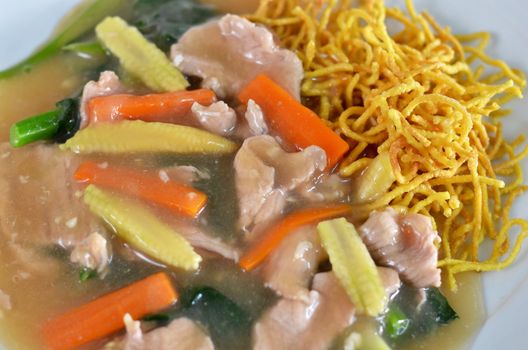 crispy yellow noodle with in a creamy gravy sauce