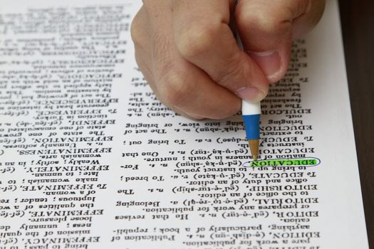 The word education highlighted with a pen.