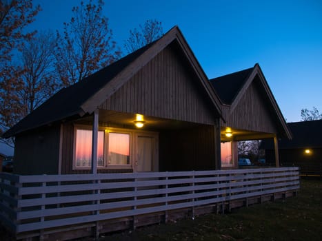 Beautiful wooden hut cabin house at night twilight 