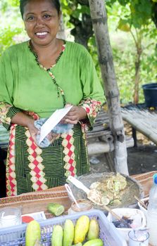 Java,Indonesia-April 21,2011:A smiling woman selling fast food near  the road 