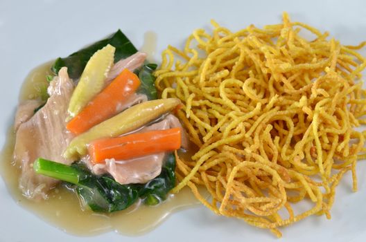 crispy yellow noodle with in a creamy gravy sauce 
