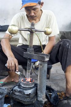 Probolingo, Indonesia - April 22, 2011: Unedentified  Indonesian man repair motorcycle inner tube