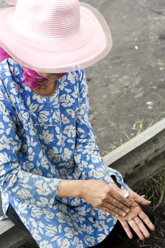 Probolingo, Indonesia - April 24,2011: Unidentified indonesian woman rolling  cigarette. Smoking in Indonesia is a common practice, as over 165 million people smoke in Indonesia. Of Indonesian people, 63% of men and 5% of women reported as smokers, a total of 34% of the population.