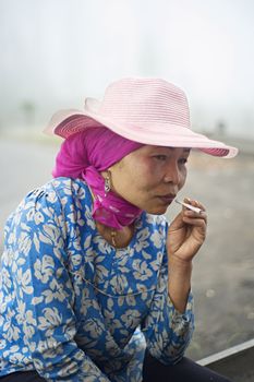 Probolingo, Indonesia - April 24,2011: Unidentified indonesian woman smoking  cigarette. Smoking in Indonesia is a common practice, as over 165 million people smoke in Indonesia. Of Indonesian people, 63% of men and 5% of women reported as smokers, a total of 34% of the population.