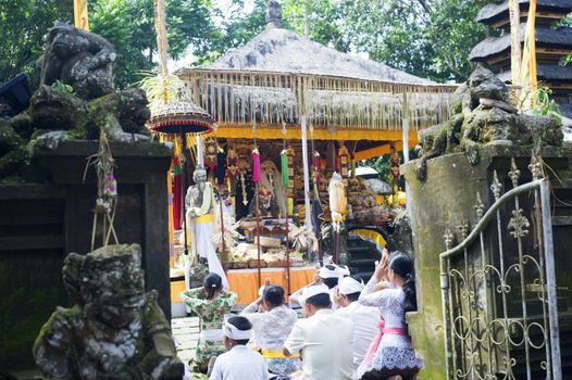 Ubud, Bali island, Indonesia - April, 30, 2011: Unidentified local people wearing in traditional indonesian clothes take part in Wayang Ceng Blonk ceremony at Hindu temple.