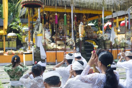 Ubud, Bali island, Indonesia - April, 30, 2011: Unidentified local people wearing in traditional indonesian clothes take part in Wayang Ceng Blonk ceremony at Hindu temple.