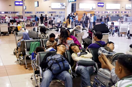 Kuala Lumpur, Malaysia - May05, 2011: People sleeping at airport as they waiting for a plane