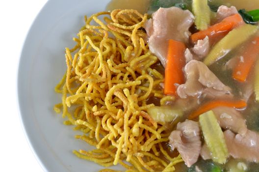 crispy yellow noodle with in a creamy gravy sauce