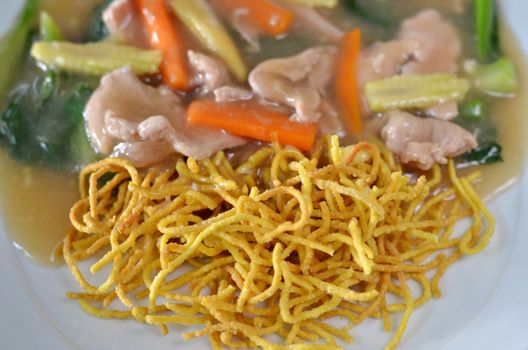 crispy yellow noodle with in a creamy gravy sauce