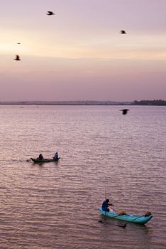 Sri lankan fishermans catching fish at sunset