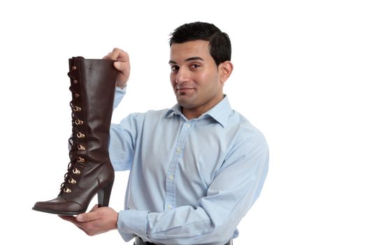 Smiling retail salesman holding or showing off a ladies leather boot.