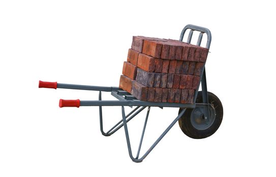 Wheelbarrow with bricks on a construction site, isolated on background