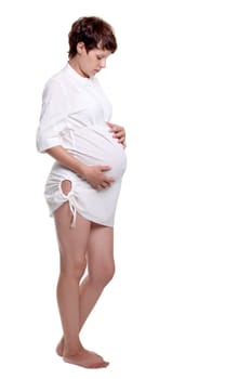 Pregnant young woman in a white shirt on the white background
