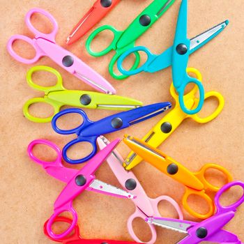 background image of many colorful plastic scissors