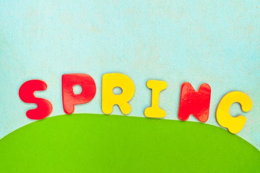 vibrant textured background of spring colours and spring in letters