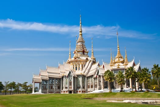 Thai white art temple against blue sky