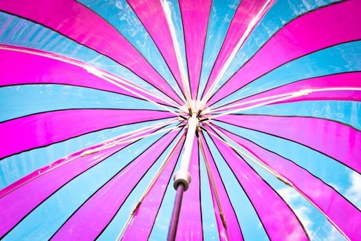 View from inside a colorful plastic umbrella