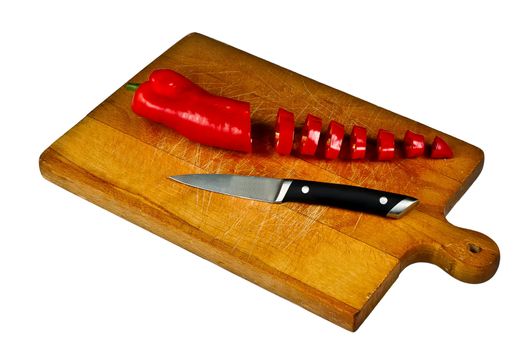 Sliced Pepper and knife on chopping board isolated on white.