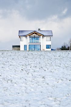 New family house in a winter meadow