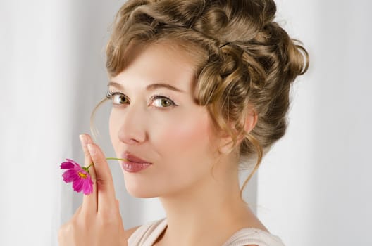 beauty woman closeup portrait with flower over grey background