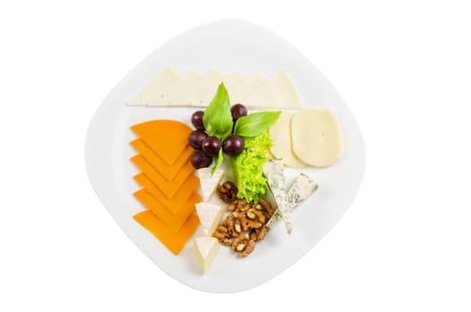 cheese with lettuce, grapes and nuts closeup on a white
